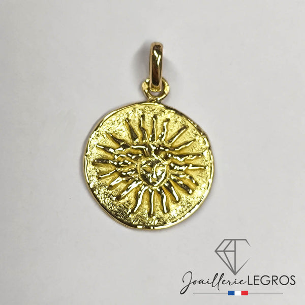 Pendentif rond en or jaune 18K (750/oo) centré d'un diamant taille